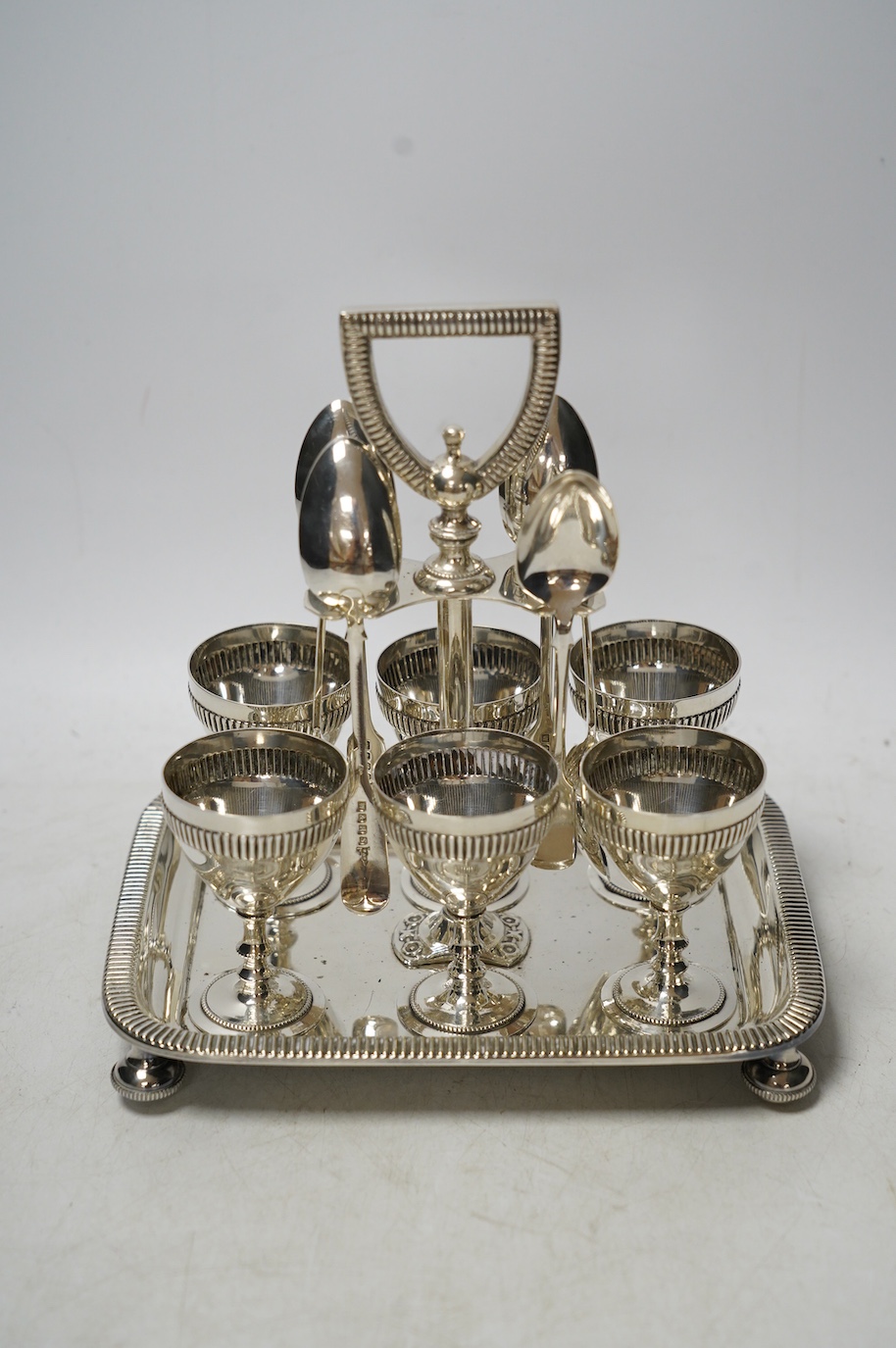 A silver plated six setting egg cruet, 19cm high. Condition - good